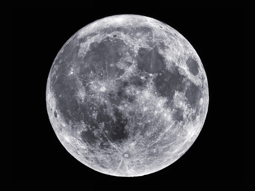 Silver full moon in a cloudless pitch-black sky