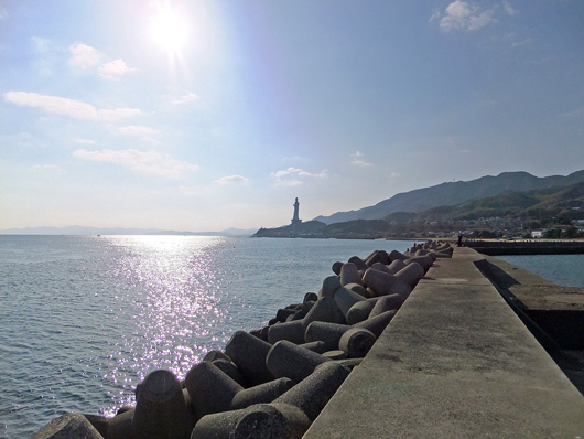 a big Kannon statue seen from the breakwater