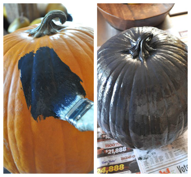 paintbrush painting black paint onto orange pumpkin