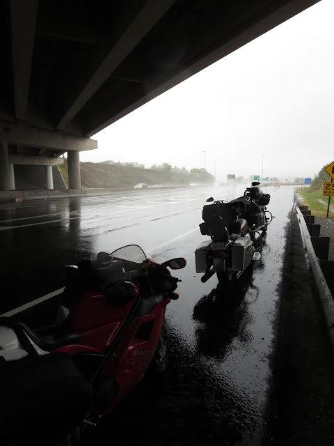 Motorcycles waiting out the rain.
