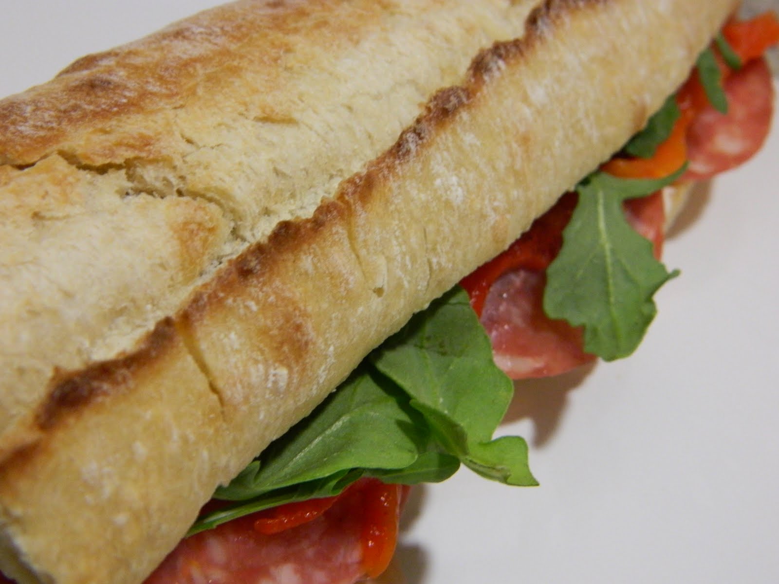 crosby beach sopressata and goat cheese sandwich with olive tapenade and roasted red peppers