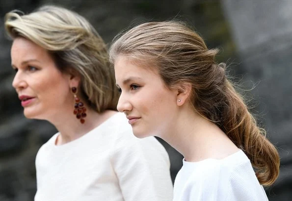 Queen Mathilde wore Dries Van Noten trousers, white bell Sleeve Stretch Crepe Top. Crown Princess Elisabeth and Princess Eleonore