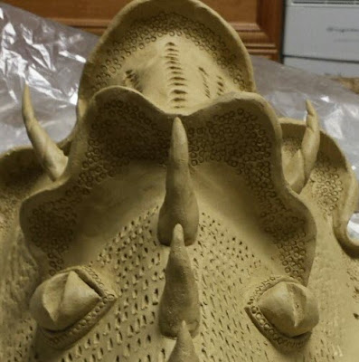 Closeup of clay dragon mask in progress, by Lily L.