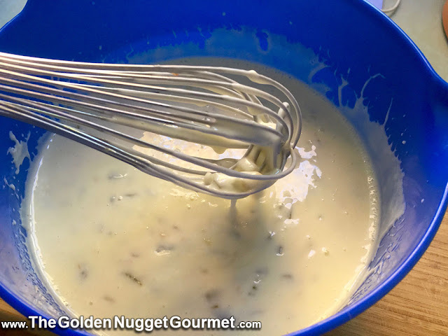 whisking copycat Moe's queso dip in bowl