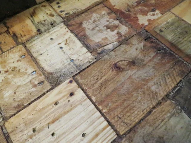 adding sawdust grout to gaps in pallet wood floor