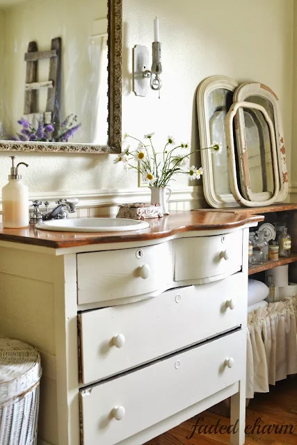 A dresser vanity / A beautifully reclaimed bathroom tour by Faded Charm, featured on http://www.ilovethatjunk.com