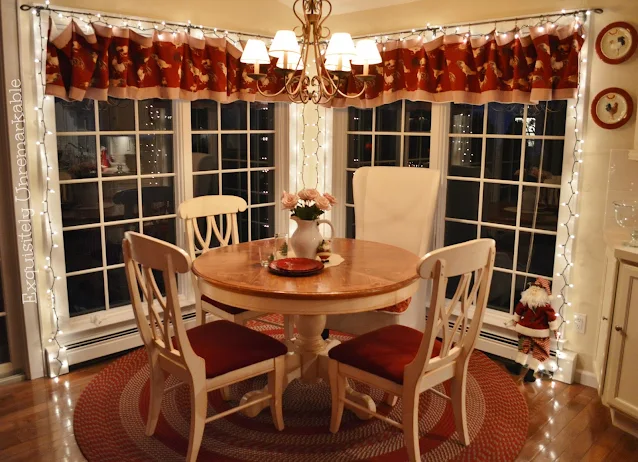 Christmas Kitchen including white lights on the windows around a round table