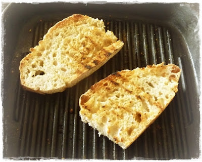 greek grilled bread cooking in a ridge pan