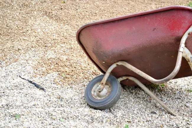 Wheelbarrow dumping pea gravel
