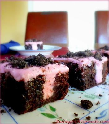 Whipped Peppermint Poke Brownies, thick chewy brownies infused with whipped peppermint frosting and topped with crunchy cookie crumbs | Recipe developed by www.BakingInATornado.com | #recipe #dessert #chocolate