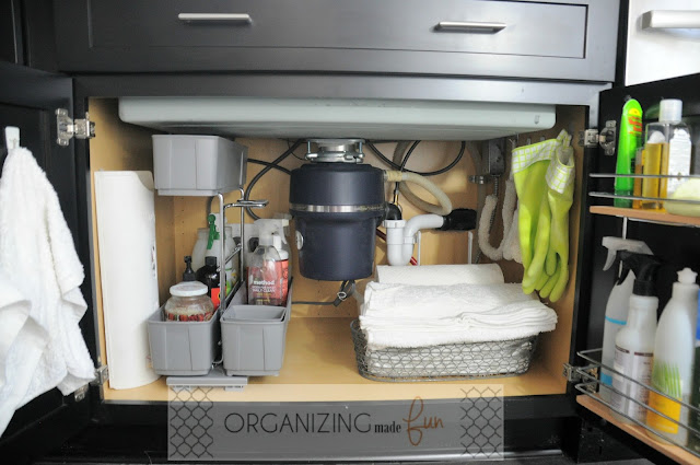 Under kitchen sink cabinet organized with cleaning supplies and terry towels :: OrganizingMadeFun.com
