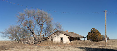 Abandoned ranch house with long porch