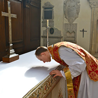 the priest kissing the altar