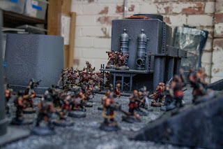 cultists lead by a dark apostle advance across the battlefield 