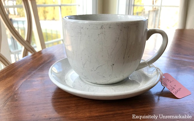 Scratched cup and saucer on a table