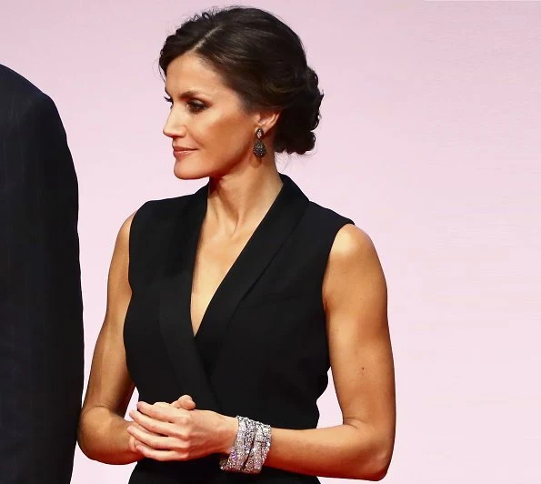 Queen Letizia wore HUGO BOSS V neck jumpsuit with satin trims. Magrit pumps, diamond earrings and baracelet