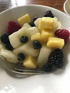 fresh fruit salad with melon raspberries and blueberries in bowl 