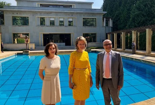 Queen Mathilde visited the Melancholia exposition held at the Villa Empain. The Villa Empain is a private house in the Art Deco style. Natan yellow lace dress