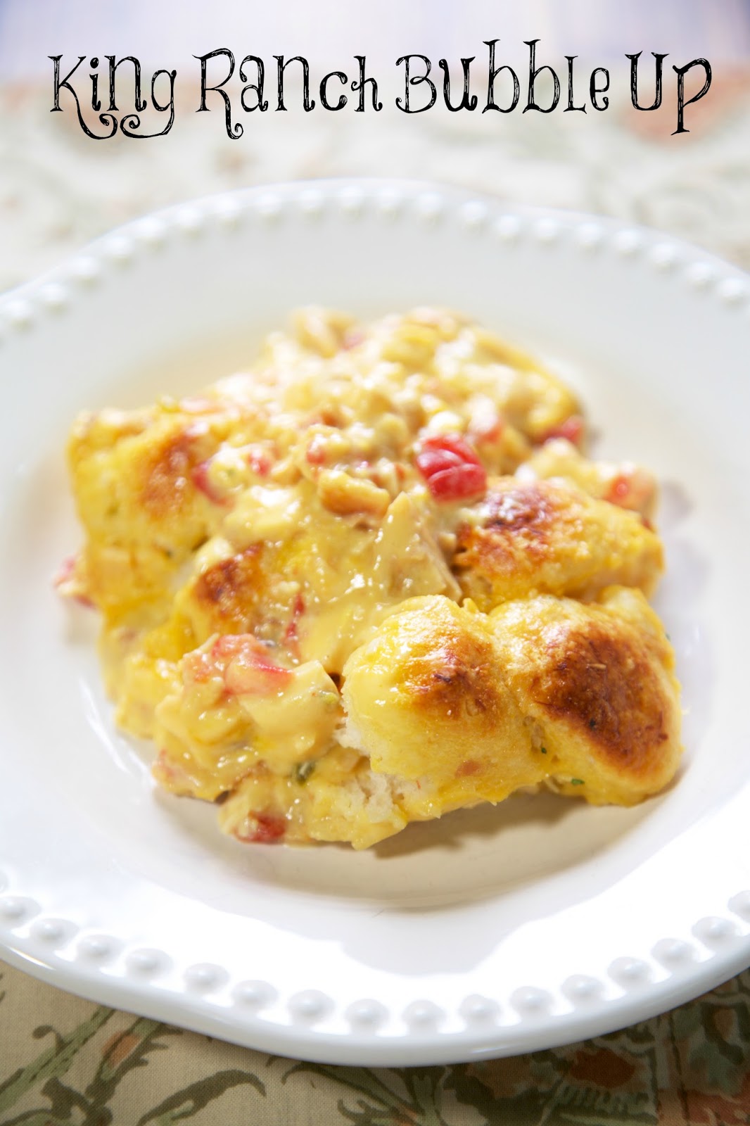 King Ranch Bubble Up Recipe - chicken, Velveeta cheese, Rotel, chicken soup tossed with chopped refrigerated biscuits and baked - use mild rotel if worried about the heat. OMG! SO easy and SO delicious! I wanted to lick my plate!