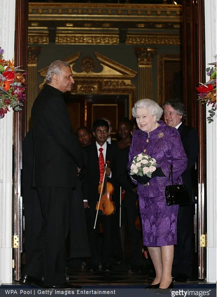 Queen Elizabeth II stands with Commonwealth Secretary-General Kamalesh Sharma during a reception to mark Commonwealth Day at Marlborough House 