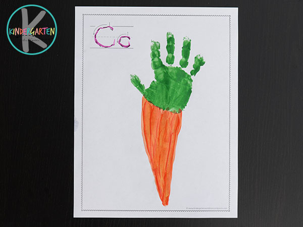 using orange paint, paint the tall triangle to make the carrot using orange paint, paint the tall triangle to make the carrot