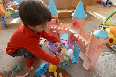 Toddler boy playing with My Little Pony Dream Castle