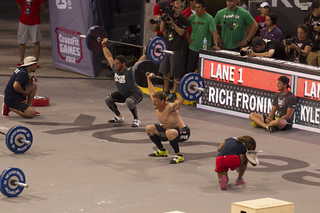 Image of athletes performing the snatch powerlifting move during the 2012 CrossFit Games