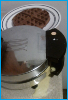 a LOT of batter leaking out of the waffle iron.  Perfect, completed waffle sitting to the side.