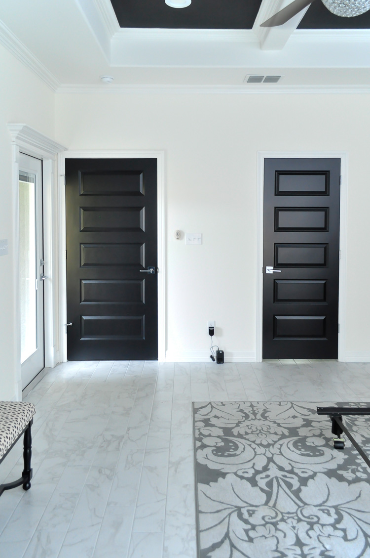 Gorgeous black interior doors set against white walls in a master bedroom. Gorgeous black interior doors set against white walls in a master bedroom.