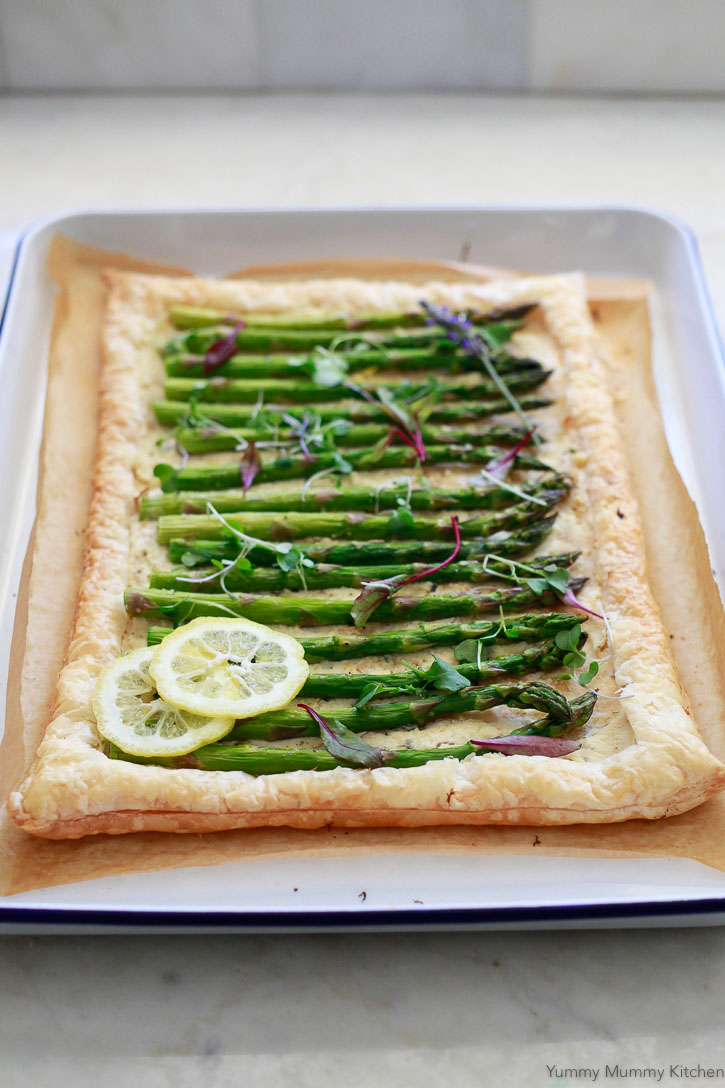 Asparagus Tart Recipe A beautiful asparagus tart on puff pastry topped with two lemon slices and fresh microgreens. This easy asparagus tart is a perfect spring, Easter, or Mother's Day appetizer.