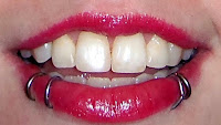 red lipstick white teeth snakebite lip rings smile happy sexy mufe 45