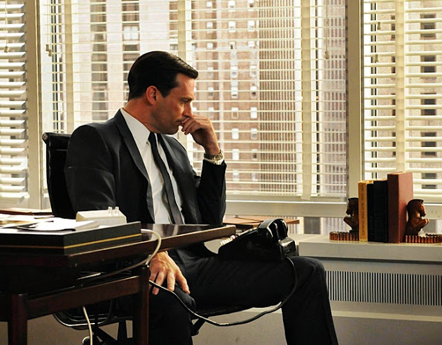 Don Draper's office space from Mad Men features dark stained wood and elegant bookends.