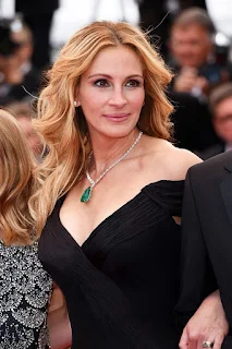 Julia Roberts smiles at the ‘Money Monster’ premiere at the 69th Cannes Film Festival, France in May 2016. She wore a black dress and accessorized with what appears to be a necklace with an emerald.