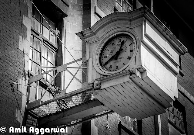 After some wonderful Photo Journeys from Shimla (IIAS, Jakhu & Sankat Mochan), here is another one by Amit Aggarwal. This Photo Journey shares more about Shimla Town and it's beauty.First photograph of this Photo Journy shows a very old Clock on Mall Road. This is places at BSNL office building, which is just in the beginning of Mall Road when we come from Himachal Pradesh University at Summer Hill.Here is a colorful building on other end of Mall Road of Shimla. Although Hotel hoardings are on left side of the building, but it's office of various High Court Advocates.Here is a main Gate of High Court Shimla. High Court Shimla is near to Mall Road and parking area is just next to mall road only.Most of the buildings around Shimla are quite interesting with slanting roofs, which are important in regions which get heavy snowfall and rains.Shimla is extremely dense and day by day it's spreading like other big cities of India. During a short visit to Shimla, every tourist like this city - It's beauty, freshness and weather. But Shimla has nt enough resources for people living there. Water is one of the biggest problem during summers. This sounds weird that hill station faces water-problem in summers, but that's true. Shimla has not big river nearby and the way population is increasing, it's always difficult to meet the requirement even when every year lot of efforts go into bringing water to the town from surrounding riversSince town was not planned to handle this much population, not we can easily see severe traffic jams around roads in Capital City of Himachal. Parking is one of the biggest problem as majority of families have four wheelers now and hardly any space to park. Tourism department has tried to solve parking problem for tourists who visit the town in their own carsColorfulness of houses in Shimla is very attractive and different from other cities. Being a hilly station, it has a big opportunity to do show-off because more number of houses can be seen at one point of time, which is not that possible in plains Here is a photograph of starting of shopping area on Mall Road, which is quite near to office of District Commissioner and Kalibari Temple. The building on left  is BSNL head office of Himachal Pradesh and on right are various showrooms having brands like Reebok, Adidas. There is a shop called 'City Point' near the beginning which is very famous for pastries..Mall road is most popular place in Shimla for Shopping. Apart from popular brands, there are some interesting shops to get woolens, stuff for kids and girls etc.Many offices of Shimla are around Mall Road and others are towards Chhota Shimla and New Shimla region. Here is a photograph showing SP office of Shimla. Most of the office buildings are old and built in British styleShimla Townhall, which is quite popular among Bollywood folks. Most of the bollywood folks who come to Shimla for shooting, choose this building of one or more shots. Movies like Kareeb are almost completely show around this place. This is center of Mall Road and most crowded place around Ridge ground of Shimla A view of beautiful Church on Ridge, Shimla. This photograph is clicked from Mall Road which is just below this Church.A view of World's highest Hanuman Statue at such a high altitude. This photograph is shot from Mall Road and this statue  is higher that these high deodar trees. It's 108 feet high ! To know more about Jakhu Temple and this Hanuman Statue, please check out - http://phototravelings.blogspot.com/2012/04/jakhu-temple-with-worlds-highest.htmlHere is a photograph of Indira Gandhi State Sport Complex which is located in the middle of Mall Road, which is just in front of HPTDC Lift. Indira Gandhi Sports Complex in Shimla is a very famous complex not only in Himachal Pradesh but also in India. It provides all required facilities for organizing events of sports as well as trade. This complex has been organizing so many events for a longer period of time. The venue is liked by sports and other event organizers as they get enjoyments together, one they do their professional work and two they get a chance to see the natural sight of Shimla. IGSS complex provides a very big space which can be utilized as per the requirement of an indoor as well as outdoor event. The complex provides good facility to sit and to enjoy for the people who get there to entertain them.