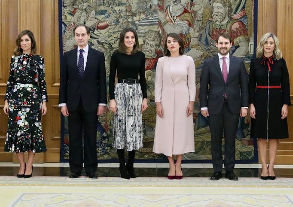 Queen Letizia wore Zara snakeskin print belted skirt, and Hugo Boss top, and Magrit suede boots at Vogue Spain