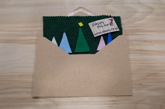 placing felt holiday card in envelope