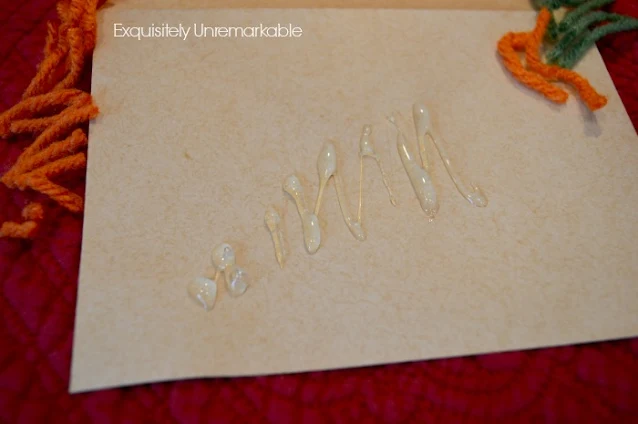 Hot glue on a brown envelope for a Easter garland DIY