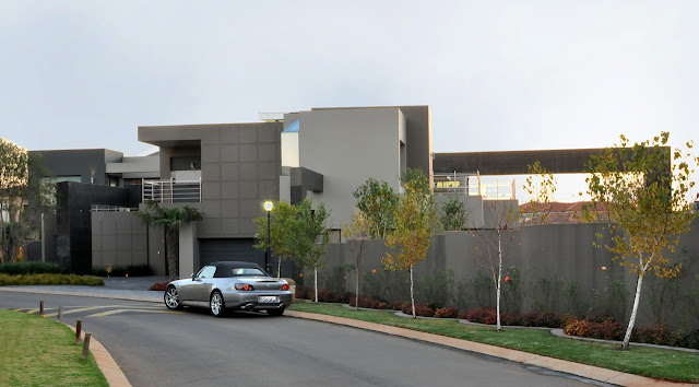 Modern home and car parked in front 
