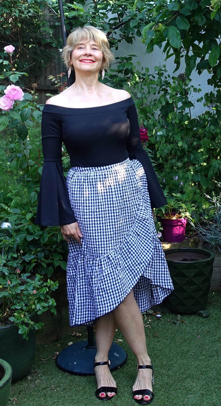 Black and white gingham skirt styled with a black Bardot top and black embellished heel sandals