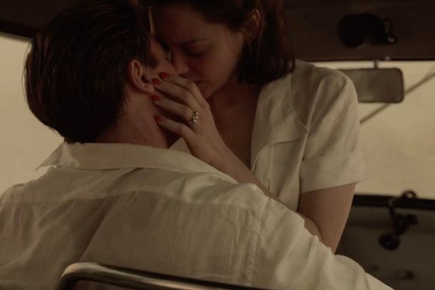 Brad Pitt and Marion Cotillard sharing a passionate moment in Allied, kiss, back of the car