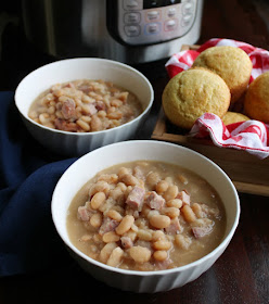 Make ham and beans in your instant pot for a satisfying meal. It's a great way to use leftover ham and there's no need to soak the beans! bowls of ham and beans with corn muffins and instant pot