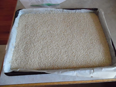 Photo of sesame seeds on parchment-lined cookie sheet