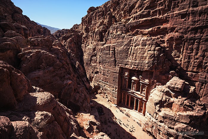 Amazingexplore The path above the royal tombs gives a bird’s eye view of the Treasury in Petra, Jordan