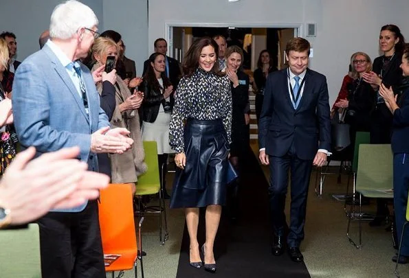 Danish Crown Princess Mary to the winner of the award, CSM's President Marianne Kirkegaard. Princess Mary wore leather skirt and print blouse