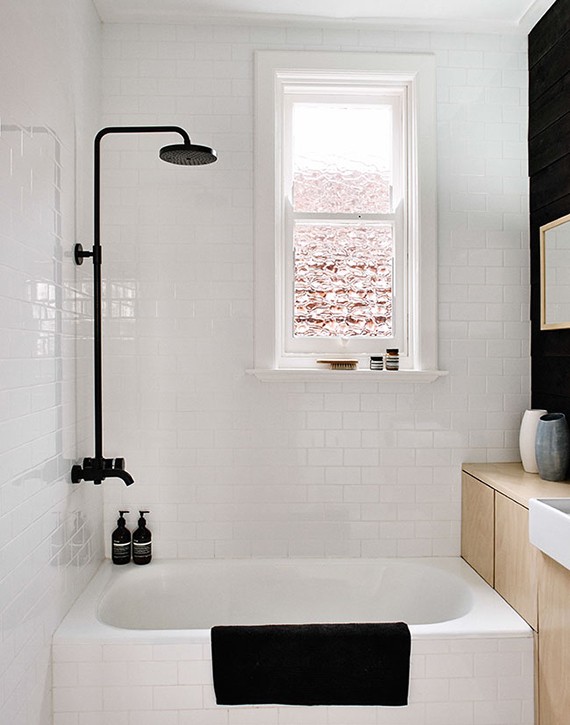 Black fixtures in the bathroom | Black shower and wall contrast with wooden cabinet and white tiles. Design by Fran Woodall, photo by Terence Chin via Sharedesign.