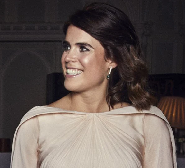 Princess Eugenie's evening dress was designed by Zac Posen, she is wearing diamond and emerald drop earrings. Princess Charlotte