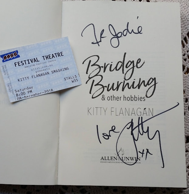 A photo of the show ticket and Kitty Flanagan's autograph on the title page of her book "Bridge Burning and other hobbies"