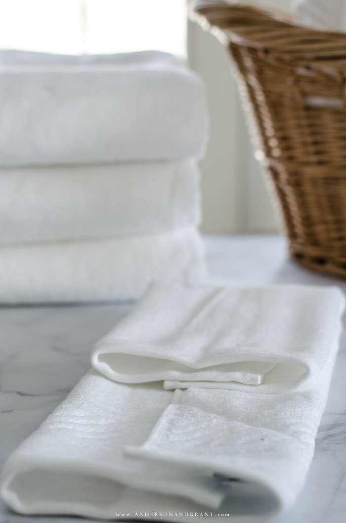 Learn the proper way to fold washcloths, hand towels, and bath towels for a neat and tidy bathroom linen closet.  |  www.andersonandgrant.com