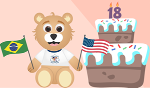 Ursinho caom bandeiras e bolo de aniversário