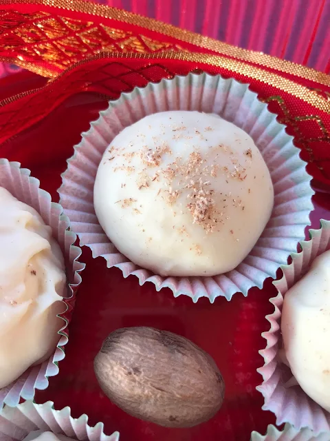 Close-up of an eggnog truffle with freshly grated nutmeg on top.